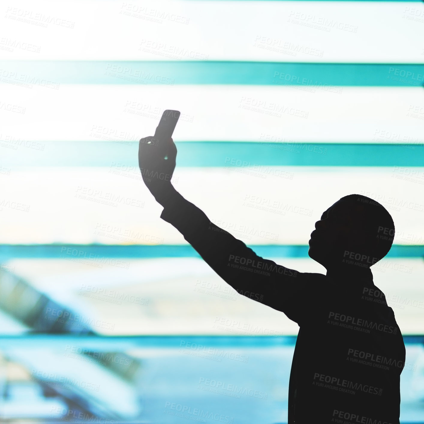 Buy stock photo Shot of an unidentifiable traveler using his smartphone in an empty airport lounge