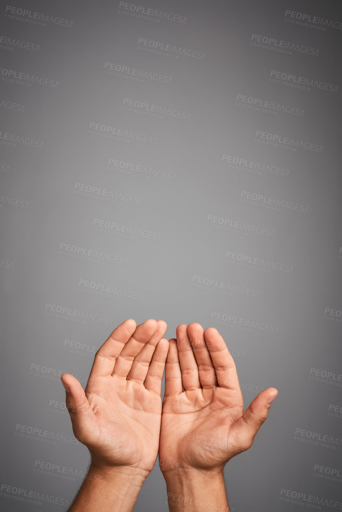 Buy stock photo Studio shot of unidentifiable hands cupped against a gray background