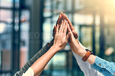 Buy stock photo Cropped shot of a group of unrecognizable businesspeople high fiving