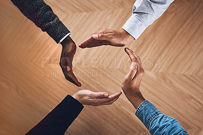 Buy stock photo High angle shot of a group of unidentifiable businesspeople forming a circle with their hands