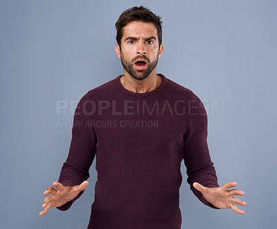 Buy stock photo Studio shot of a handsome young man looking angry against a gray background