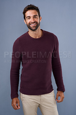 Buy stock photo Studio shot of a handsome and happy young man posing against a gray background