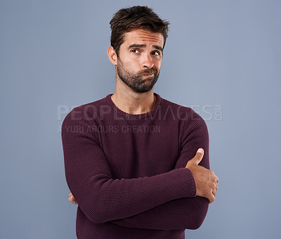 Buy stock photo Studio shot of a handsome young man looking thoughtful against a gray background