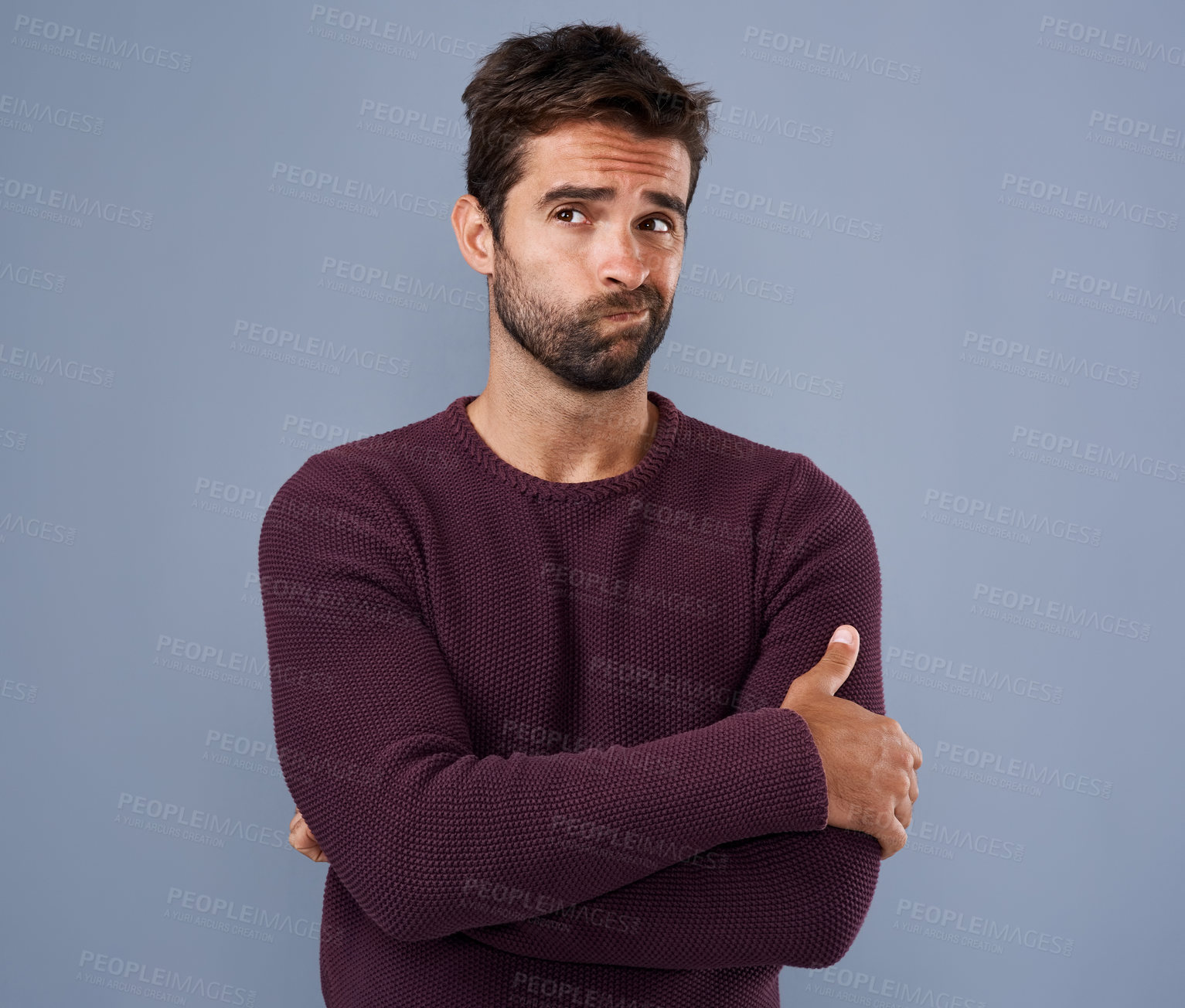 Buy stock photo Studio shot of a handsome young man looking thoughtful against a gray background