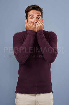 Buy stock photo Portrait, afraid and phobia of man in studio, anxiety and biting of nails for stress, scared and fear. Blue background, mockup space and person with terror for nightmare of fail in test of college