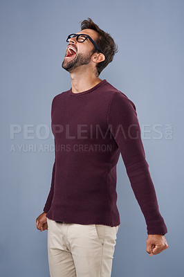 Buy stock photo Studio shot of a handsome young man screaming in anger against a gray background