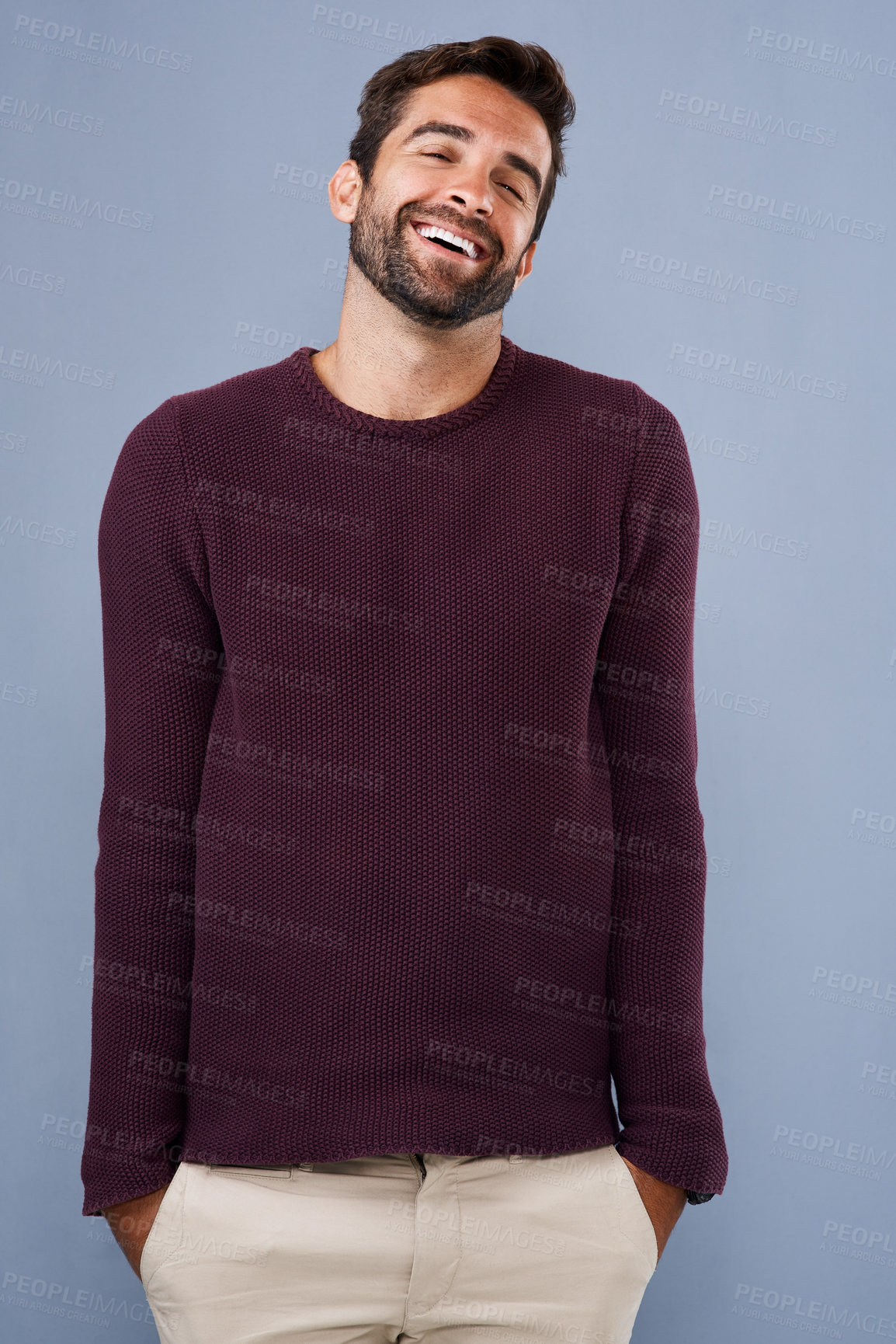 Buy stock photo Studio shot of a handsome and happy young man posing against a gray background