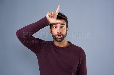 Buy stock photo Studio, portrait and man with loser sign for feedback, opinion and wrong decision with emoji reaction. Facial expression, hand gesture and male person with silly for review, choice or gray background