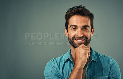 Buy stock photo Studio portrait of a handsome young man posing against a grey background