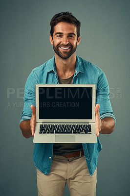 Buy stock photo Happy man, laptop and portrait with mockup screen for advertising or marketing against grey studio background. Male person showing technology or computer display or mock up space for advertisement