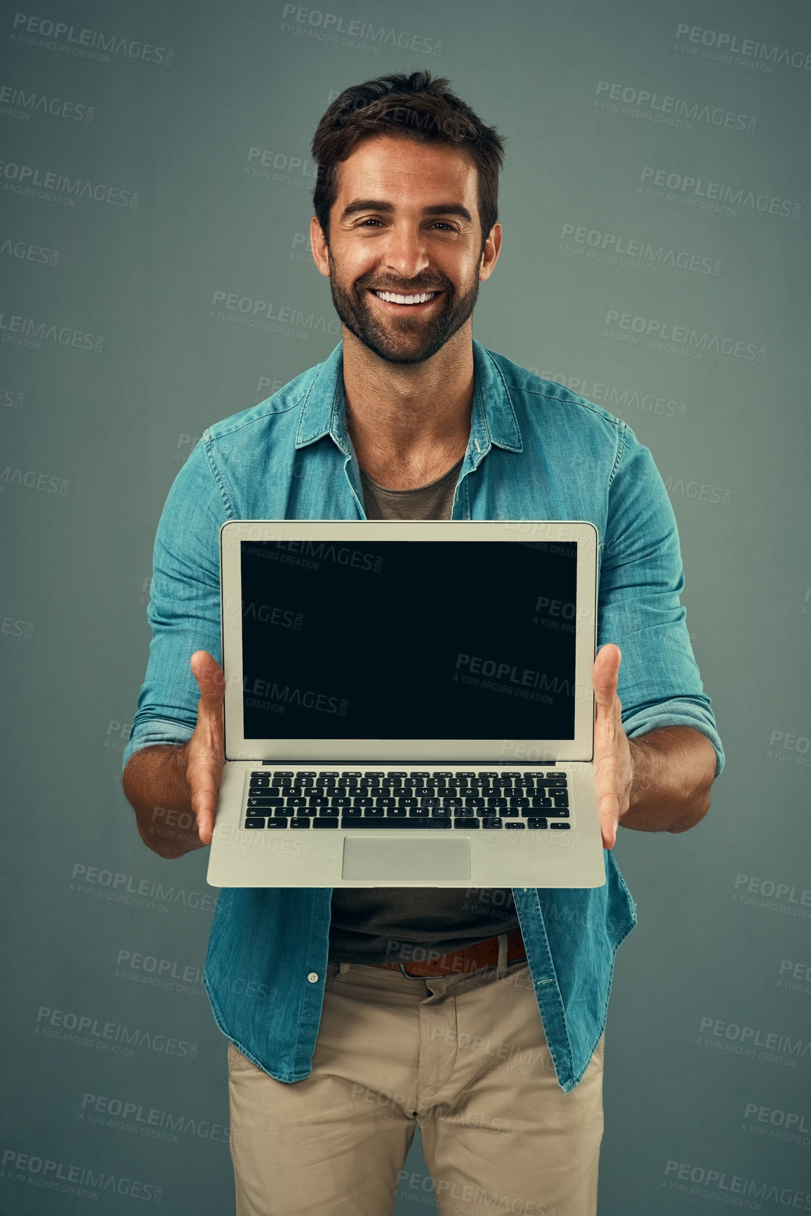 Buy stock photo Happy man, laptop and portrait with mockup screen for advertising or marketing against grey studio background. Male person showing technology or computer display or mock up space for advertisement