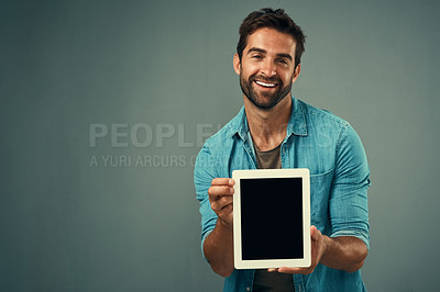 Buy stock photo Happy man, tablet and advertising screen on mockup for marketing or branding against a grey studio background. Male person with smile showing technology display or mock up space for advertisement