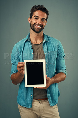 Buy stock photo Happy man, tablet and portrait with mockup screen for advertising or marketing against grey studio background. Male person with smile showing technology display or mock up space for advertisement