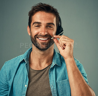 Buy stock photo Happy man, headphones and portrait smile of call center consultant against a grey studio background. Face of friendly male consulting agent smiling with headset mic in contact us for online advice