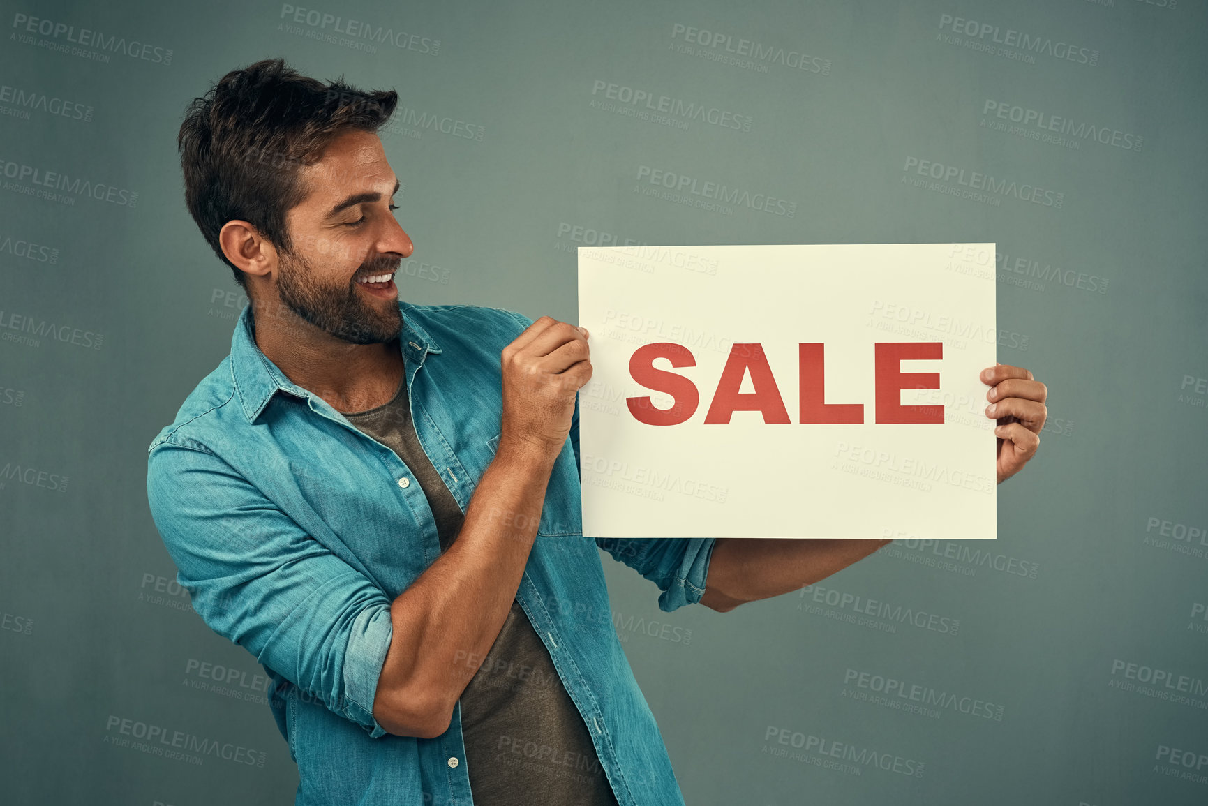 Buy stock photo Happy man, hands and sale sign for advertising, marketing or branding against a grey studio background. Male person or realtor holding board or poster with smile for sales or market advertisement