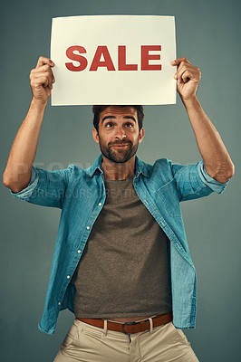 Buy stock photo Man, hands and sale on billboard for advertising, marketing or branding against a grey studio background. Male person or realtor holding board, sign or poster for sales announcement or advertisement