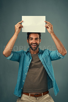 Buy stock photo Happy man, portrait and mockup billboard for advertising, marketing or branding against a grey studio background. Male person holding rectangle poster, placard or board for sign or advertisement