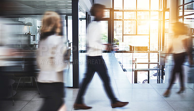 Buy stock photo Shot of businesspeople walking in a busy office