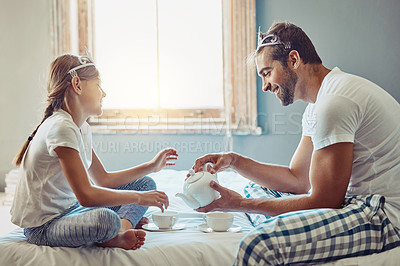 Buy stock photo Shot of a father and daughter having a tea party at home