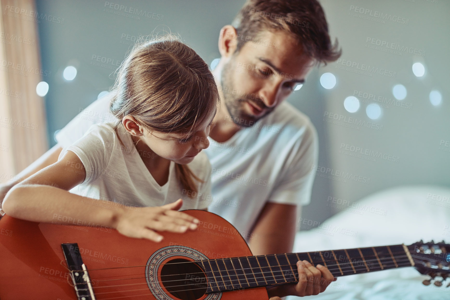 Buy stock photo Man, girl and kid in guitar teaching and learning at home, bonding with love and creativity. Family, father and daughter learn to play musical instrument, focus in lesson and music education help