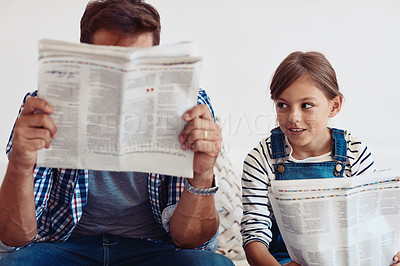 Buy stock photo Shot of an adorable little girl spending time with her father at home