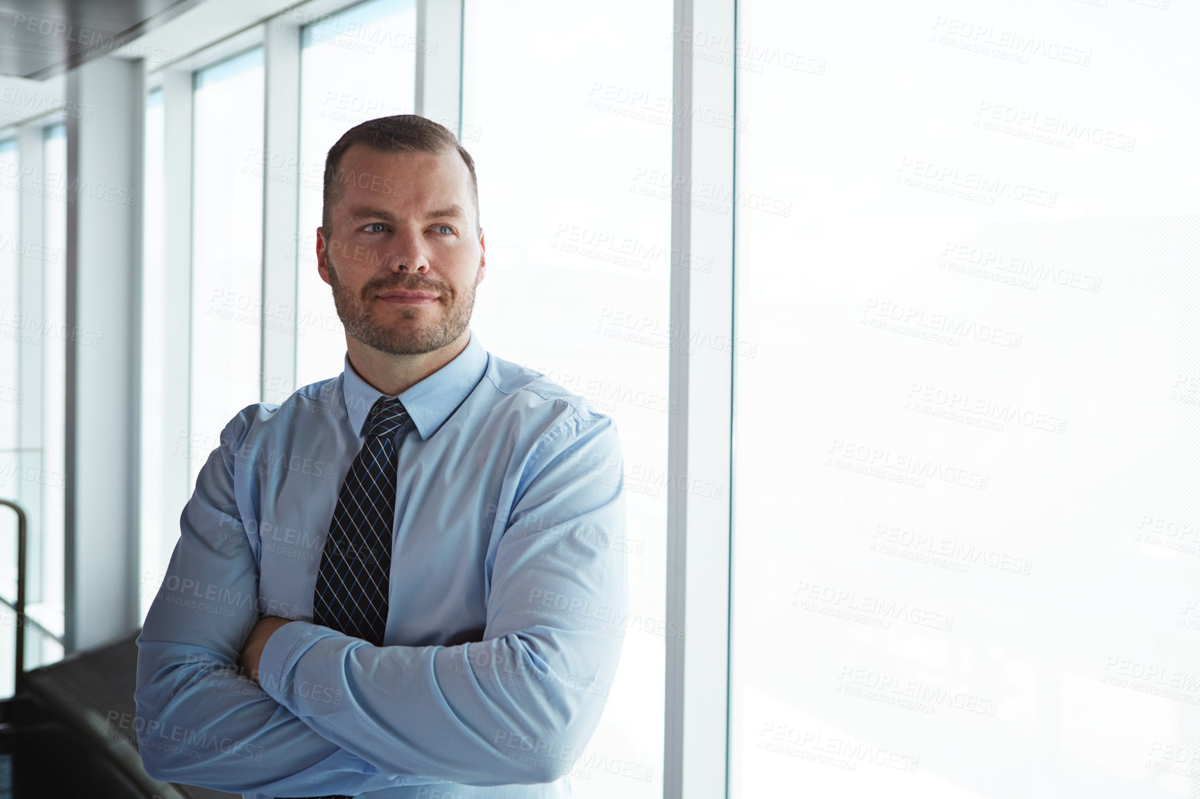 Buy stock photo Shot of a smiling businessman posing in an airport terminal