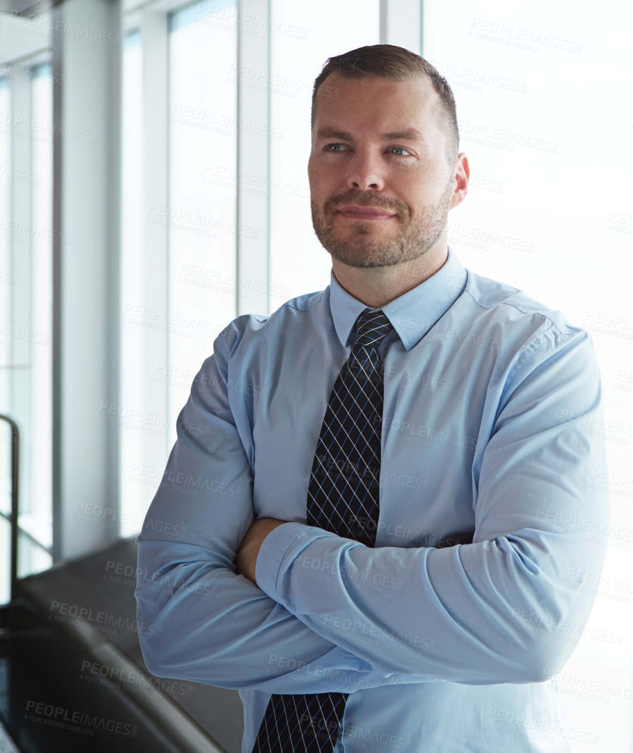 Buy stock photo Shot of a smiling businessman posing in an airport terminal