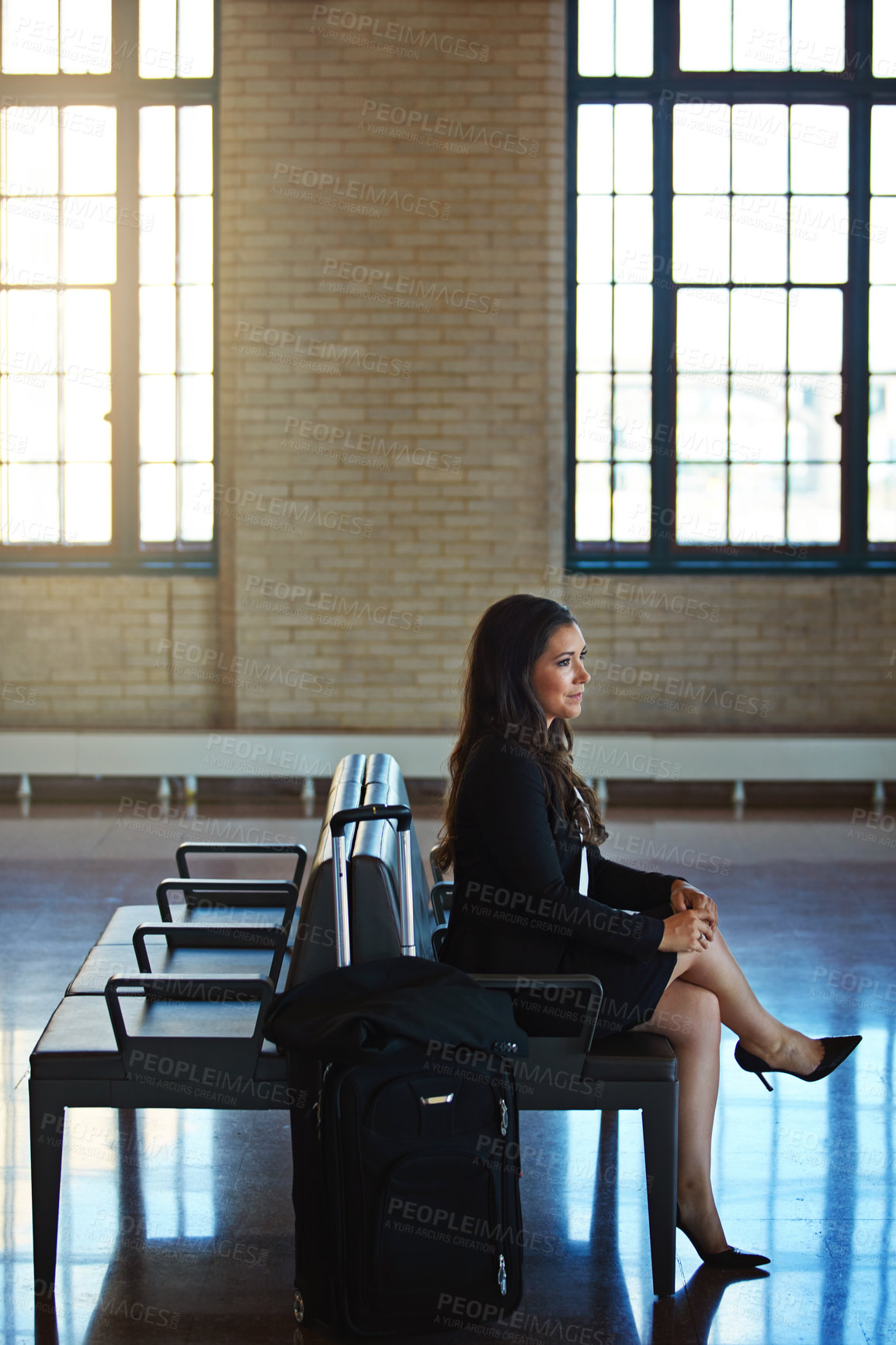 Buy stock photo Shot of a confident businesswoman  waiting in an airport terminal while on a business trip