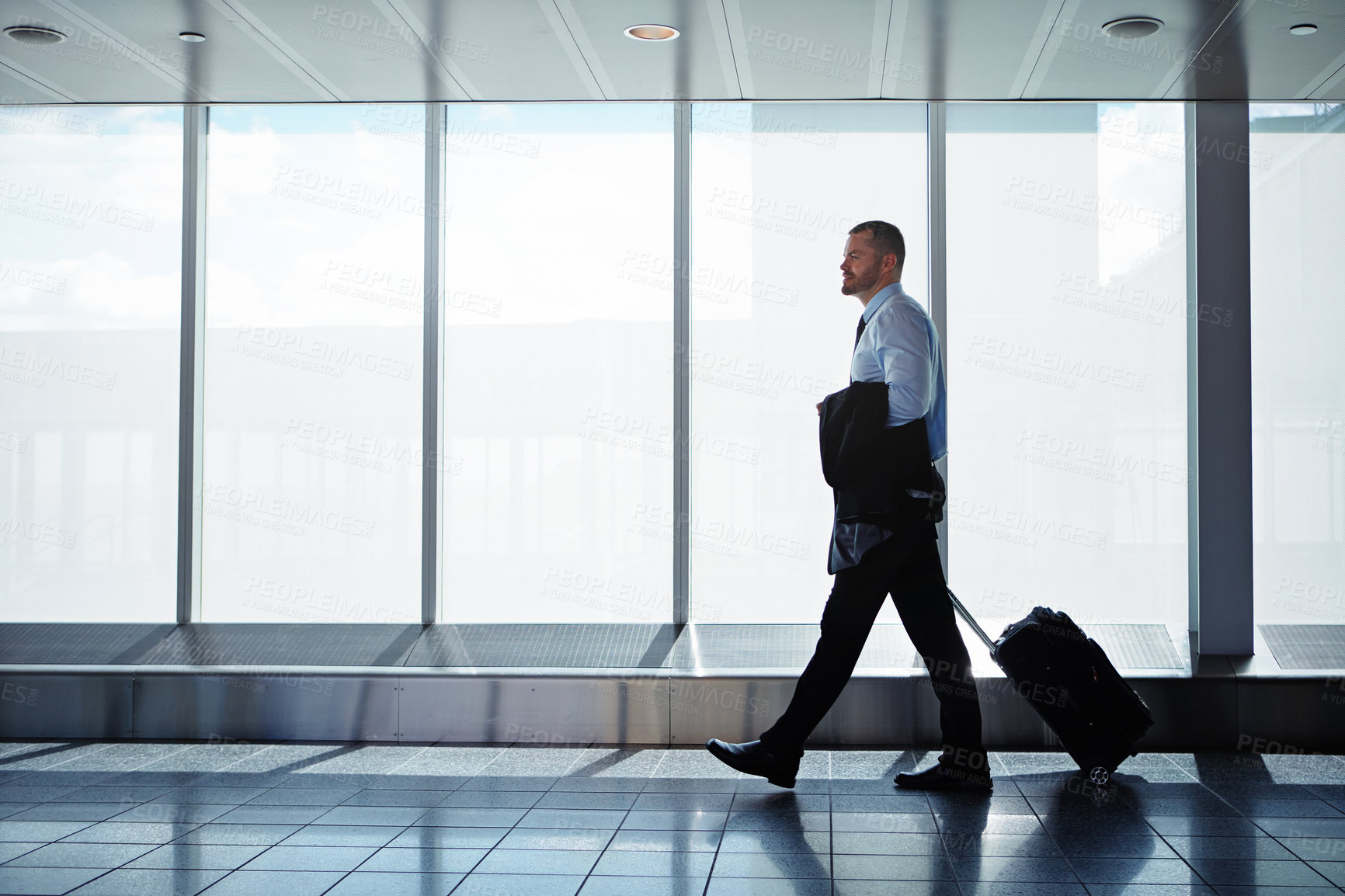 Buy stock photo Thinking, businessman and journey in airport with luggage, immigration and decision while walking. Vision, person and professional with suitcase for international flight, work trip and travel idea