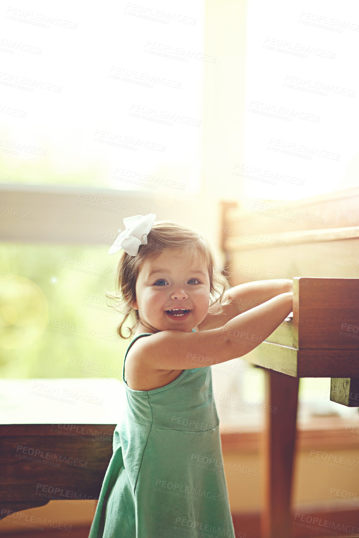 Buy stock photo Girl, toddler and portrait by piano in home for musical development, learning and growth of motor skills or creativity. Child, instrument and happiness in house for entertainment, education and sound