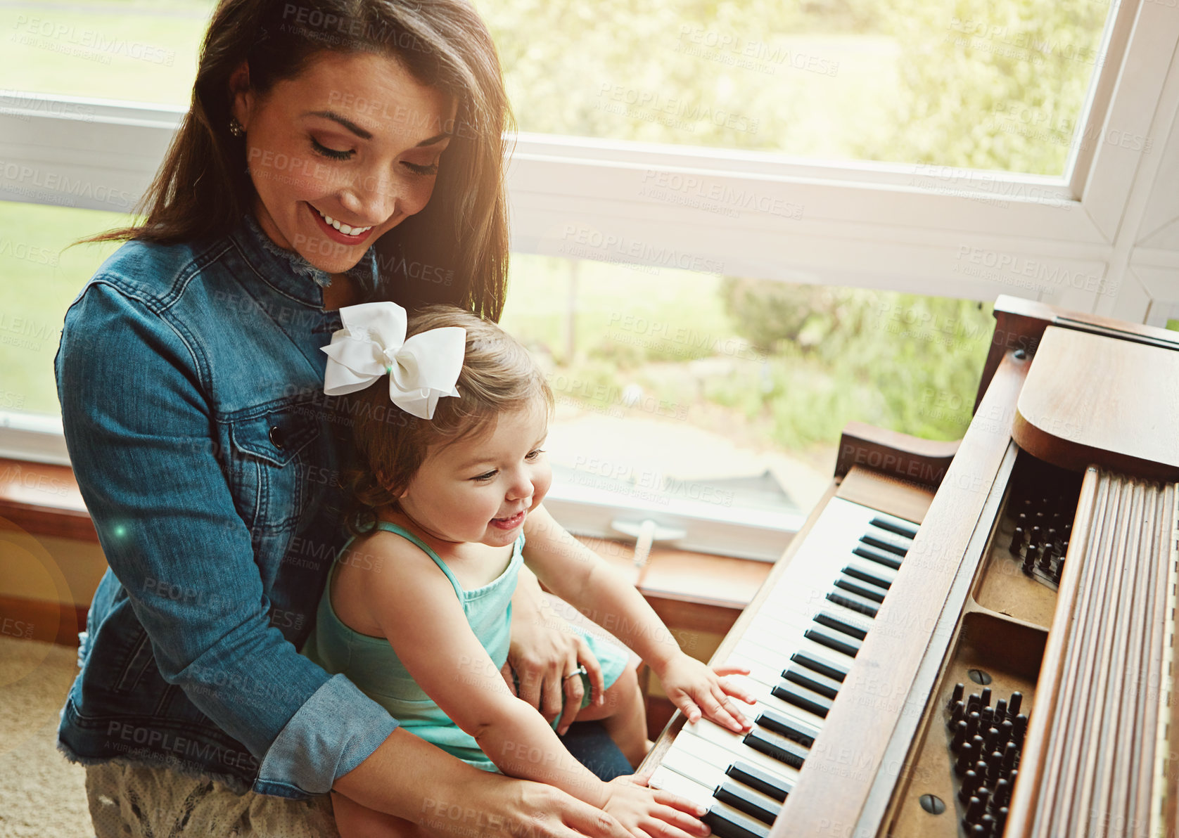 Buy stock photo Happy family, child and mother by piano for learning music and play at home in support, love and fun. Woman or mom with kid, girl or baby on instrument keys for sound development, teaching or bonding