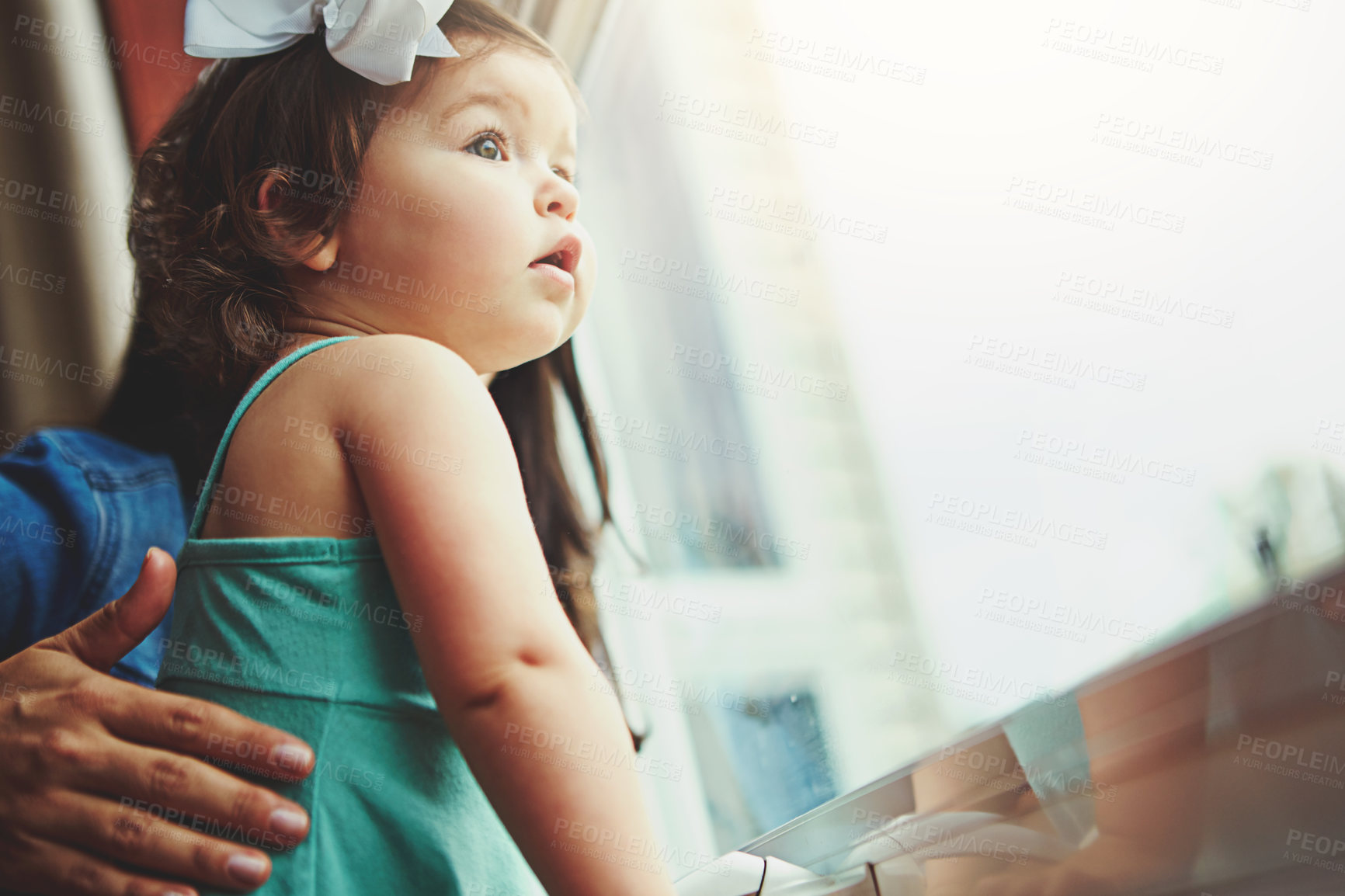 Buy stock photo Cropped shot of a mother and her adorable little daughter looking out the window at home