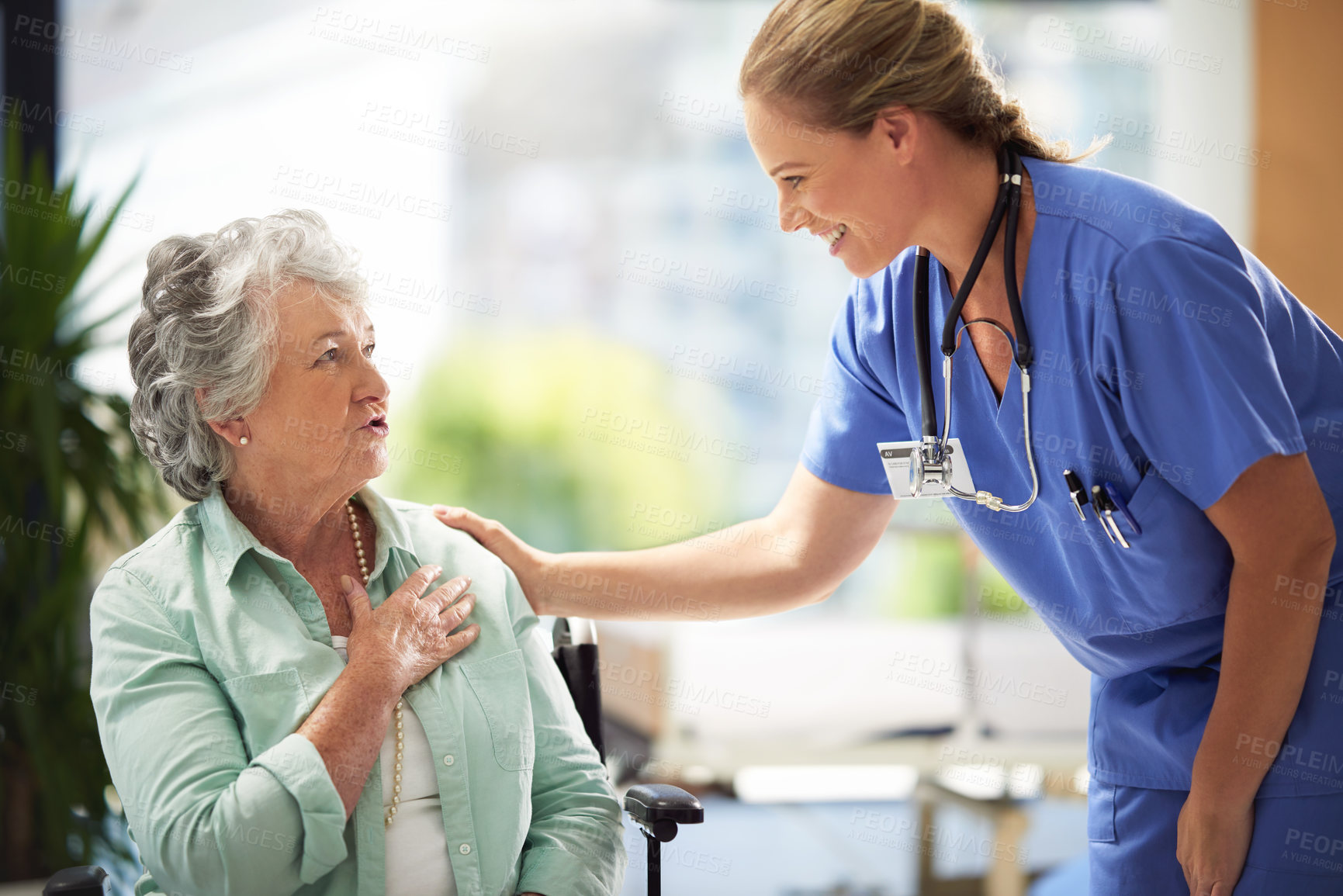 Buy stock photo Shot of a carer at a nursing home with her patient