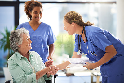 Buy stock photo Handshake, nurse and senior woman in wheelchair with medical results and surgery success news. Hospital, healthcare and clinic with women and nursing staff with care and support of elderly person