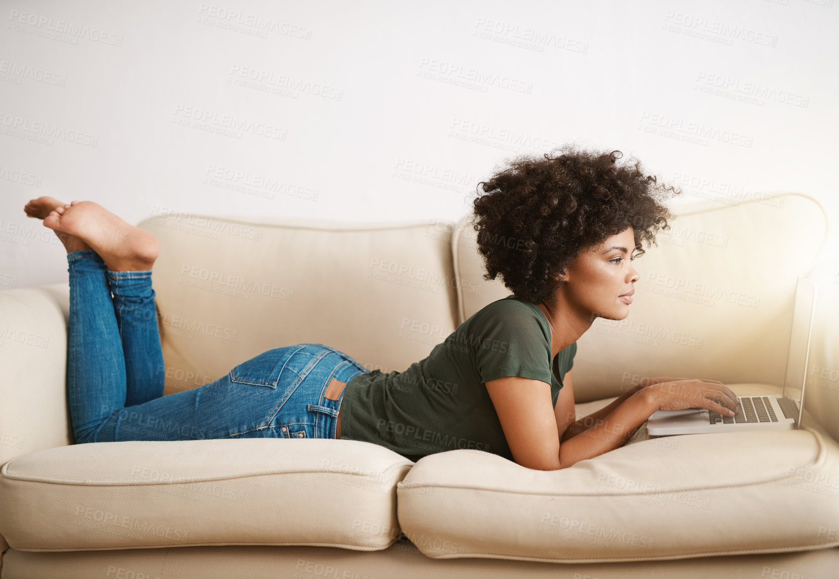 Buy stock photo Black woman, laptop and relax on couch for reading ebook, streaming movies and weekend peace in home. African lady, computer and rest on sofa for social media post, watch documentary and blog update