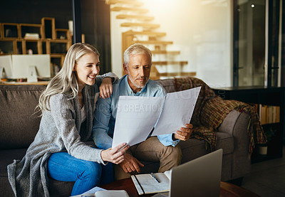 Buy stock photo Cropped shot of a couple going through their paperwork together at home