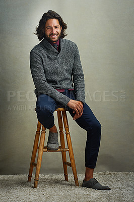 Buy stock photo Portrait of a stylishly dressed man sitting on a stool in the studio