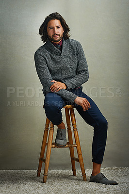 Buy stock photo Portrait of a stylishly dressed man sitting on a stool in the studio
