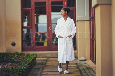 Buy stock photo Outdoor, woman and walking at spa on holiday, relax and break for luxury and mindfulness. Female person, resort and wellbeing or self care on vacation, trip and travel for wellness at hotel with gown
