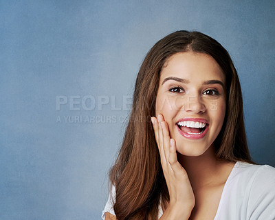 Buy stock photo Portrait, skincare and beauty of excited woman with glow, shine or dermatology on blue studio background. Face, hairstyle and happy model with makeup, cosmetics and spa facial treatment for results