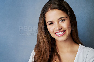 Buy stock photo Studio shot of an attractive young woman posing against a gray background