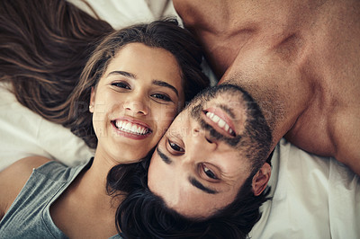 Buy stock photo Happy, portrait and couple on bed in home for relaxing morning on weekend together from above. Smile, love and face of young man and woman resting in bedroom for bonding and connection at house