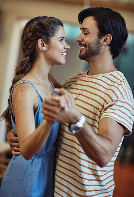 Buy stock photo Happy, couple and love with dancing in home for romantic connection, bonding and care in marriage. Man, woman and smile with holding hands in living room for anniversary, loyalty and trust on weekend