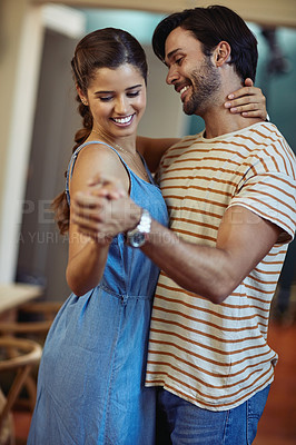 Buy stock photo Happy, couple and care with dance in home for romantic connection, bonding and loyalty in marriage. Man, woman and smile with holding hands in living room for anniversary, love and trust on weekend