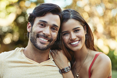 Buy stock photo Portrait of a happy young couple posing together outside