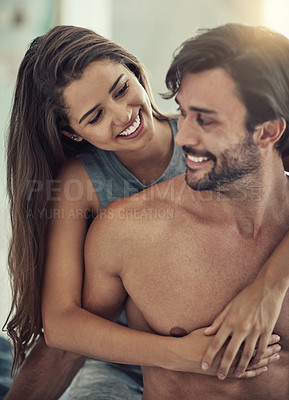 Buy stock photo Cropped shot of an affectionate young couple sitting down in their bedroom