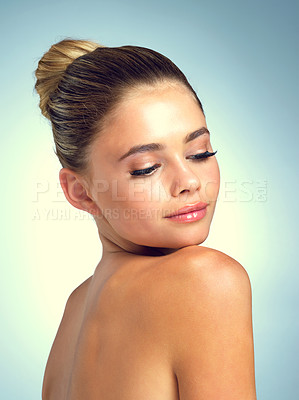 Buy stock photo Studio shot of an attractive young woman posing against a gray background