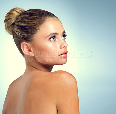 Buy stock photo Relax, thinking and woman in studio with skincare, natural beauty and luxury cosmetics on mockup space. Dermatology, facial care and girl with confidence, makeup and healthy skin on blue background