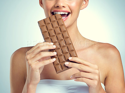 Buy stock photo Studio shot of an attractive young woman posing against a gray background