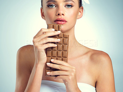 Buy stock photo Studio, portrait and woman with chocolate for eating, snack and dessert for female person. Serious, girl and sweets for mood enhance, candy and cognitive benefits for memory by white background